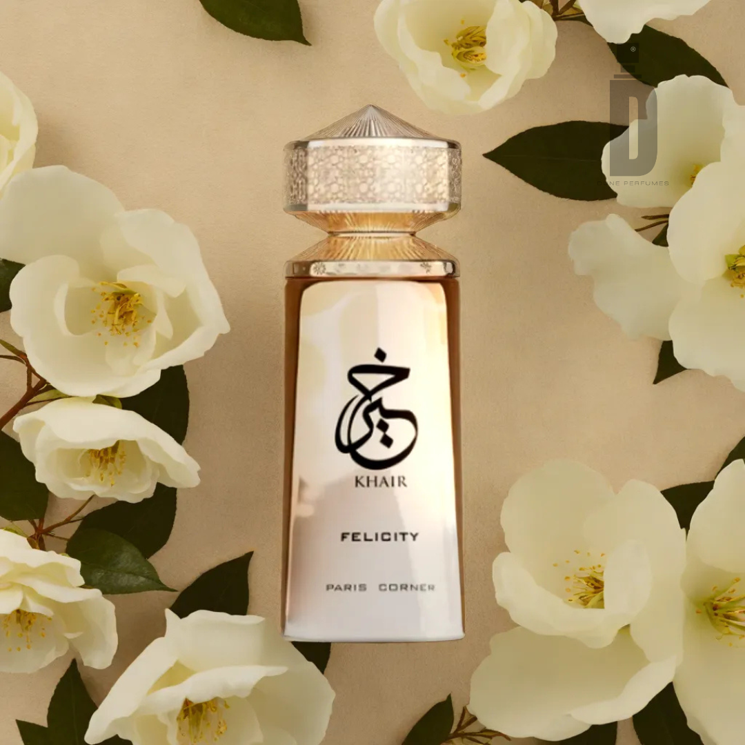 The Khair Felicity 100ml EDP by Paris Corner stands elegantly amidst cream flowers and lush greenery, with a faceted cap enriching its luxury and capturing the fragrance's enchanting allure.