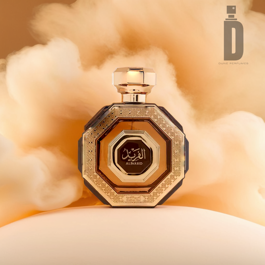 An Al Fareed 100ml EDP bottle from Arabian Oud, showcasing a hexagonal design, rests against a soft, cloud-like background. It features elegant gold and black accents with Arabic script adorning its label. The captivating allure of oud is perfectly captured in its bold fragrance notes, while the top right corner is elegantly marked with a logo that reads "Arabian Oud.