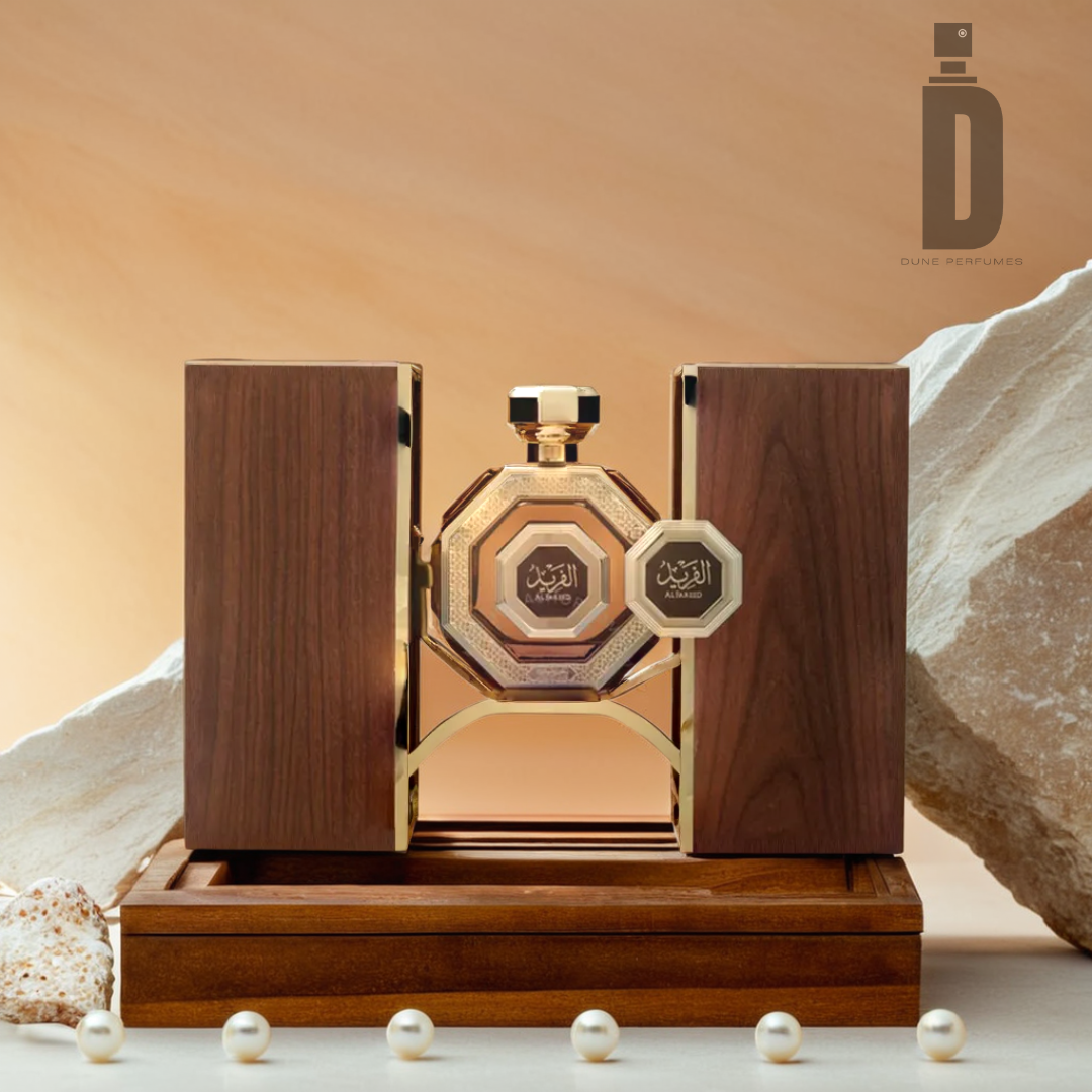 A luxurious Al Fareed 100ml EDP by Arabian Oud, infused with musk, sits elegantly on a wooden display with a geometric design. The background features a contrasting blend of smooth stones and a beige surface, accentuated by scattered pearls. The logo of "Arabian Oud" is visible in the top right corner.