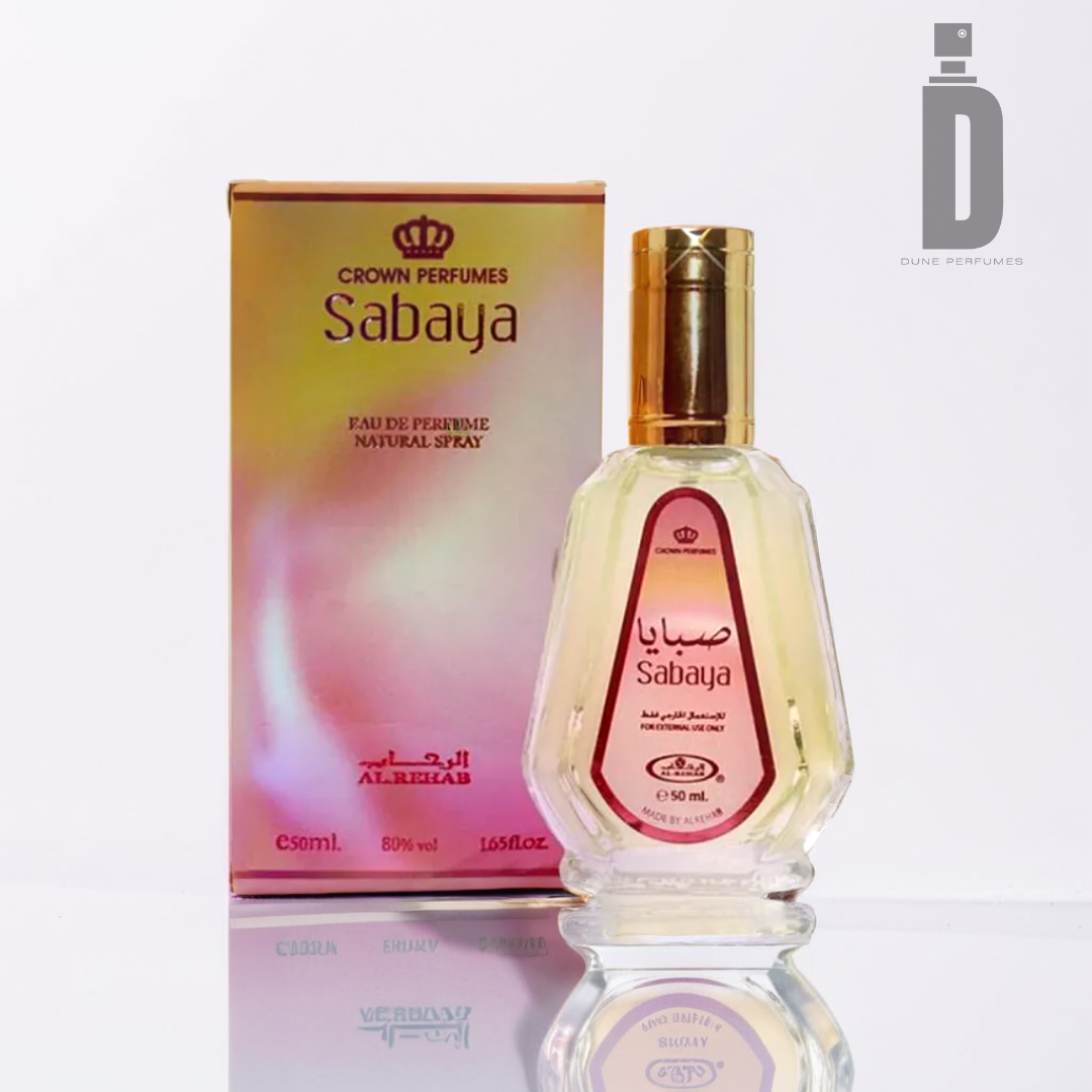 A bottle of Sabaya 50ml EDP from Al Rehab is elegantly displayed in front of its coordinating box. The clear bottle, adorned with a gold cap, exudes a floral fragrance. The pink and gold box prominently showcases the Al Rehab logo in the top right corner, suggesting refreshing citrus notes inside.