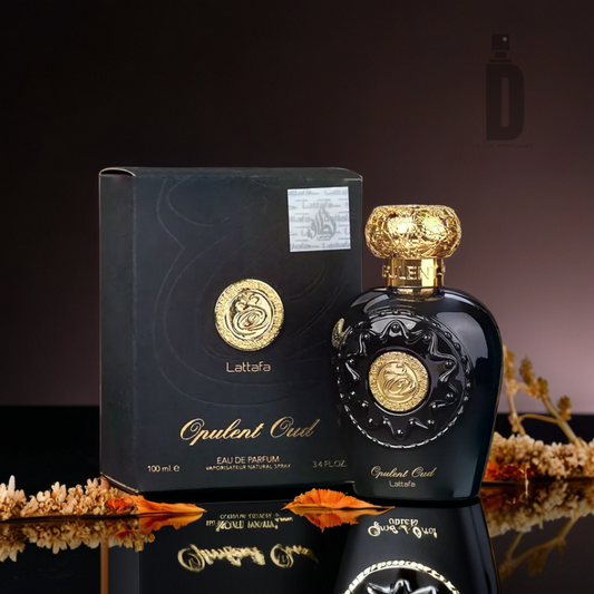 A luxurious black bottle of Opulent Oud 100ml EDP by Lattafa is showcased alongside its elegant matching box. The bottle boasts intricate gold details and a decorative cap, positioned against a dark gradient backdrop with autumn leaves, subtly alluding to hints of saffron and agarwood (oud).