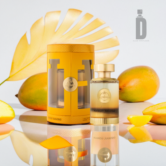 A 100ml bottle of Paris Corner's "Mango Jugoso" EDP is showcased alongside its coordinating yellow packaging. The scene is set against a background of ripe mangoes, mango slices, and a large yellow leaf on a shiny surface, evoking an exotic and refreshing atmosphere.