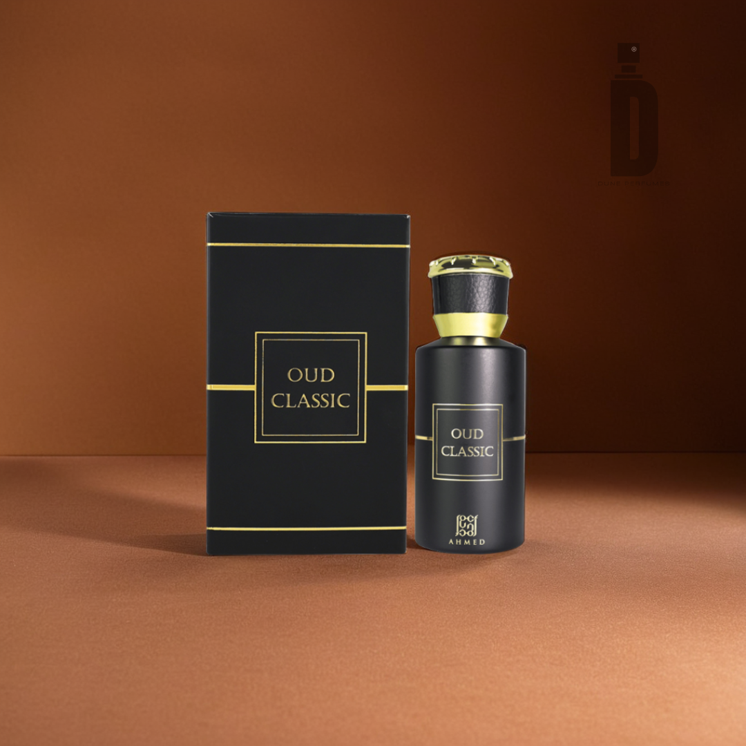 The "Oud Classic 50ml EDP - Ahmed Al Maghribi" perfume is displayed alongside its coordinated black and gold box. Both the bottle and the box are adorned with an elegant label on a warm brown background, capturing a sophisticated woody fragrance that provides a perfectly balanced scent.