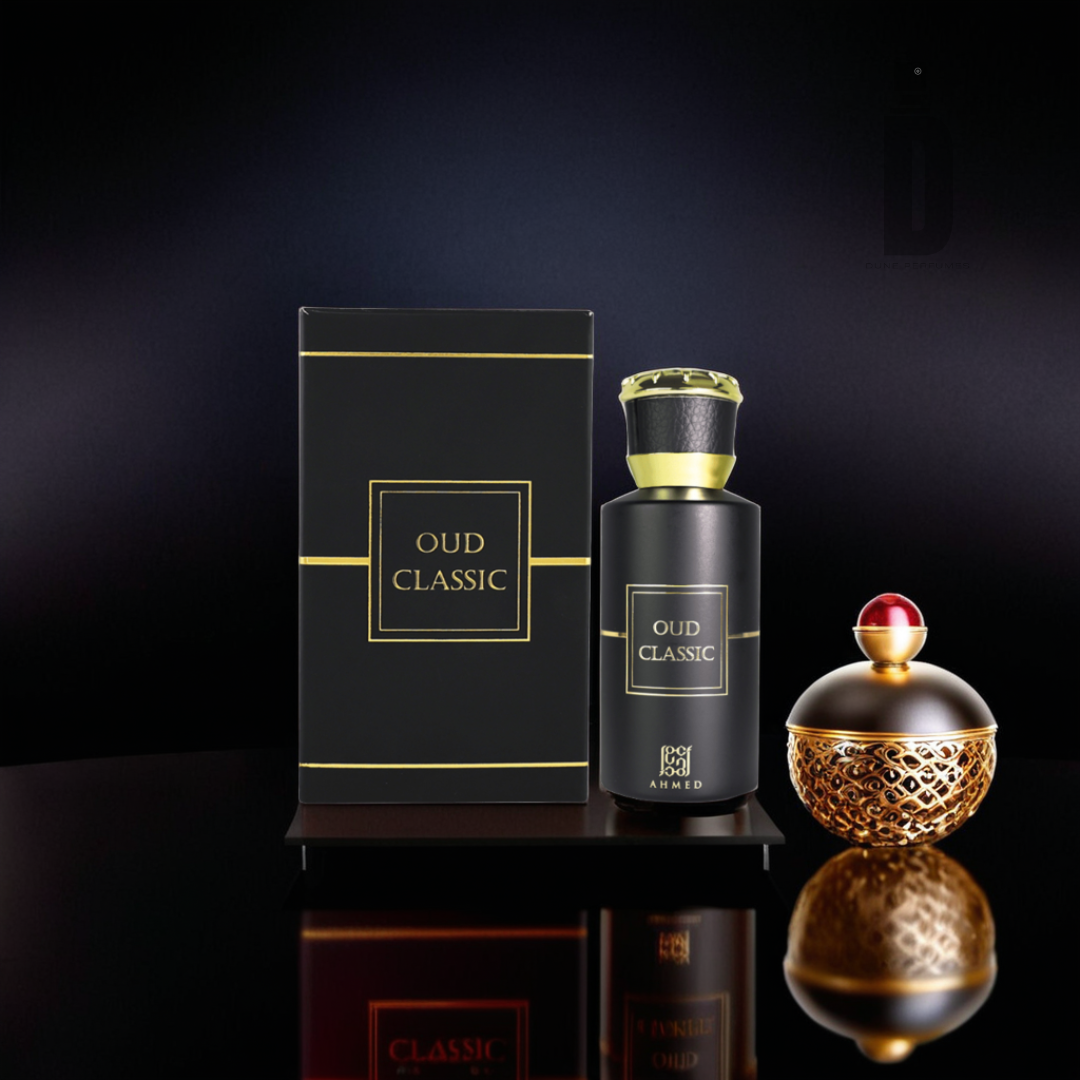 A sleek black box labeled "Oud Classic 50ml EDP - Ahmed Al Maghribi" stands beside a matching bottle adorned with gold accents, embodying a balanced scent. A small, ornate container featuring a red and gold design reflects light on the glossy surface, hinting at the woody fragrance within.