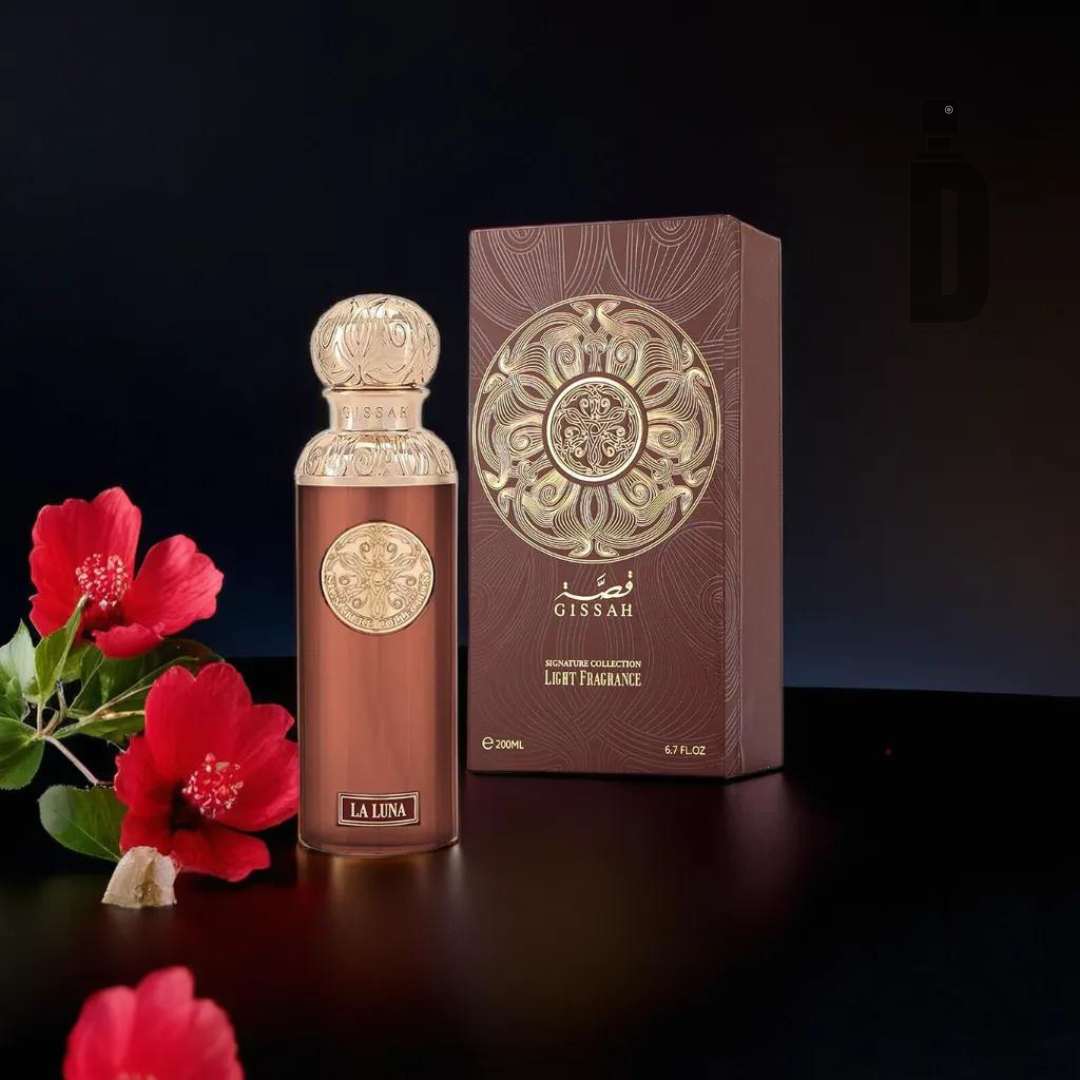 A luxurious bottle of La Luna 200ml EDP by Gissah sits next to an ornate brown and gold box with intricate detailing. Red hibiscus flowers lie in the foreground on a dark surface, adding a touch of elegance to the scene, while hinting at the captivating fragrance perfect for evening wear.