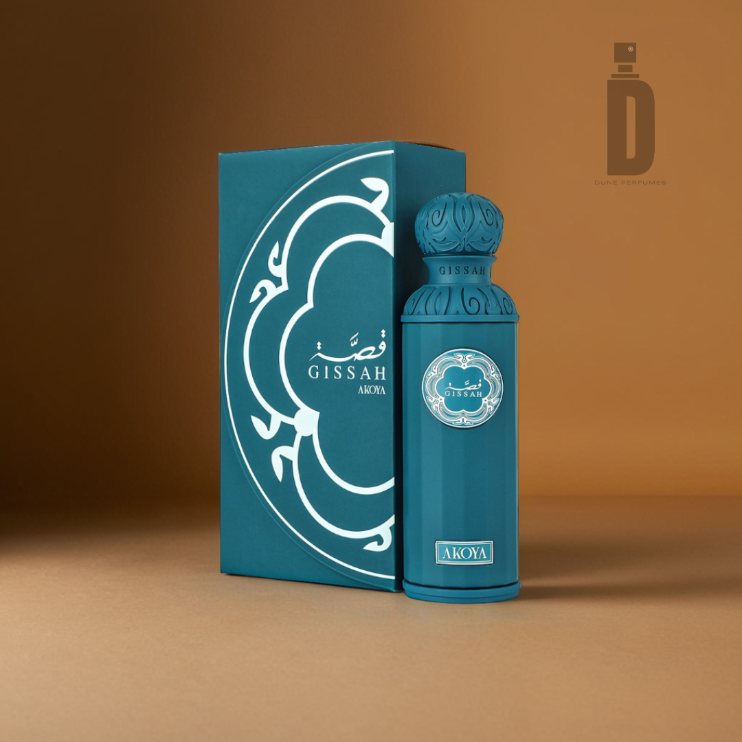 A teal perfume bottle labeled "Akoya 200ml EDP - Gissah" is positioned beside its matching box, embellished with intricate white designs and radiating a sensual depth. The background is a warm brown shade, and the logo for "Gissah" is visible in the top right corner.