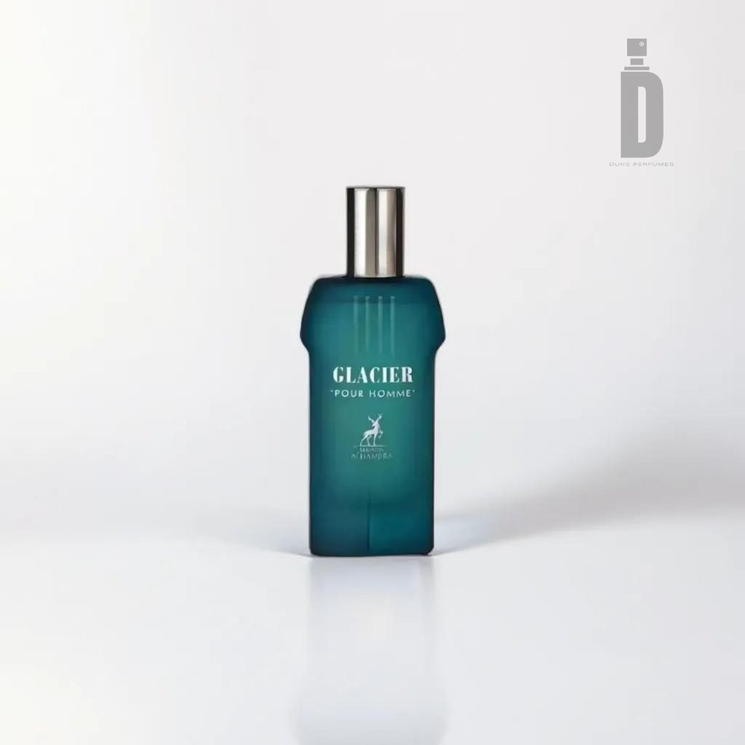 A photograph of a blue-tinted, rectangular perfume bottle with a silver cap. The label reads "GLACIER POUR HOMME" in white text, with an emblem of a gazelle below it. This sophisticated cologne for men, Glacier Pour Homme 100ml EDP from Maison Al Hambra, is set against a plain white background with a faint shadow beneath the bottle.