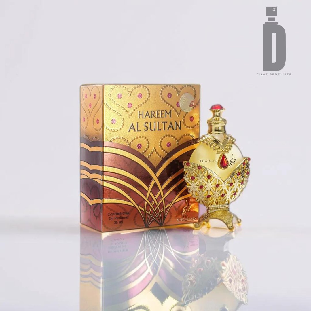 A luxurious perfume bottle and box set, branded "Hareem Al Sultan Gold 35ml Perfume Oil - Khadlaj." The ornate gold bottle features intricate red and gold detailing and is shaped like an elegant vase. This concentrated perfume oil comes in a matching box with a rich, golden design and text reading "Khadlaj" and "Concentrated Oil 35 ml.