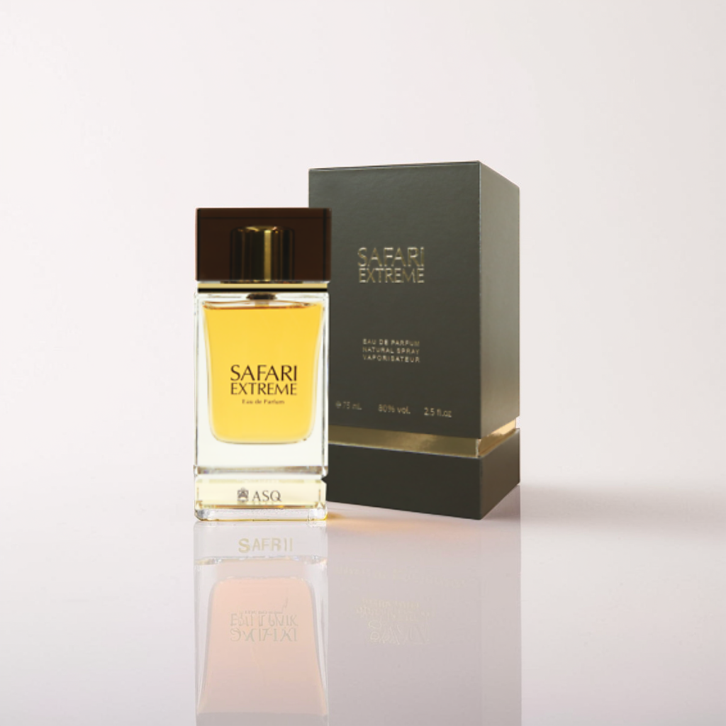 The 75ml Safari Extreme Eau de Parfum by Abdul Samad Al Qurashi is showcased with its packaging. The fragrance comes in a rectangular bottle of amber-hued liquid, topped with a dark cap, while the box is set upright on a reflective surface.