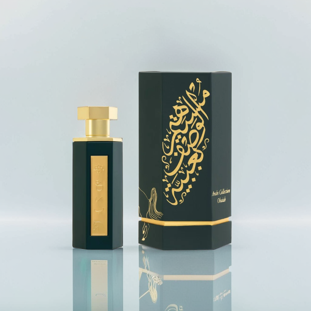 The Obaiah 100ml EDP by Reef features a luxurious dark green bottle with a gold cap and ornate gold Arabic script, echoing its rich oud essence. The matching box also showcases elegant gold Arabic writing, embodying sophistication.