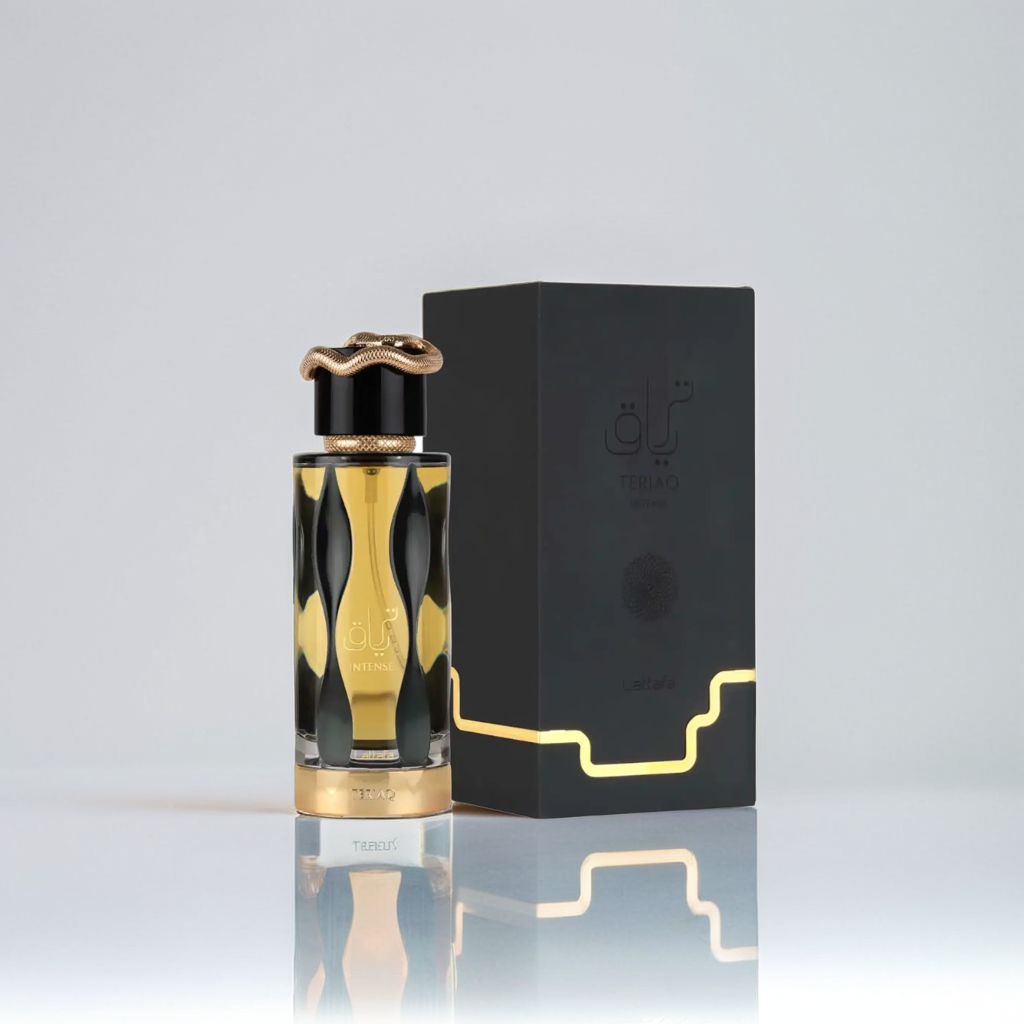 The Teriaq Intense 100ml EDP by Lattafa features an artistic, wavy black and gold design. Its ornate gold cap and reflective base complement the matching box, while a simple light background enhances the elegance of this luxurious fragrance.