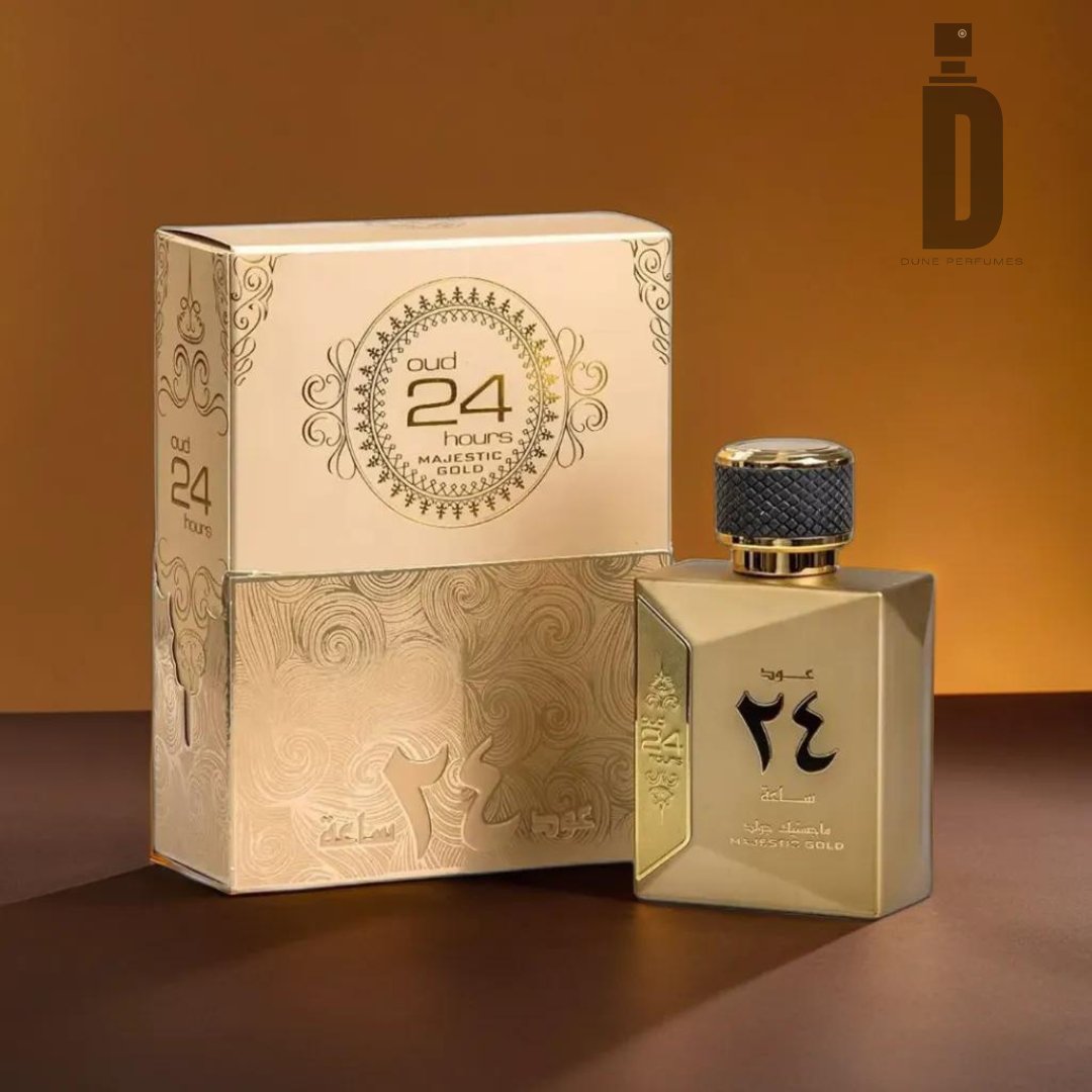 A golden perfume bottle featuring a patterned cap is labeled "Oud 24 Hours Majestic 100ml EDP - Ard Al Zaafaran." Beside it sits the matching box adorned with intricate designs and the same label. The background showcases a warm gradient of brown and gold tones, capturing the rich essence of agarwood.