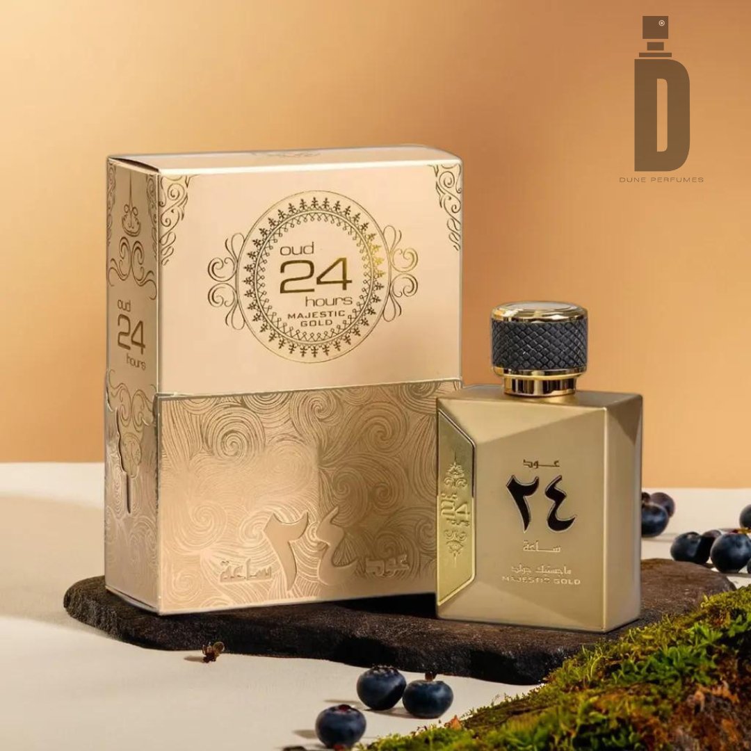 A stylish perfume bottle labeled "Oud 24 Hours Majestic 100ml EDP - Ard Al Zaafaran" stands next to its ornate packaging. The box features intricate patterns and golden accents. The background includes small dark berries and a patch of moss, evoking the rich, luxurious essence of black orchid for a sophisticated scene.